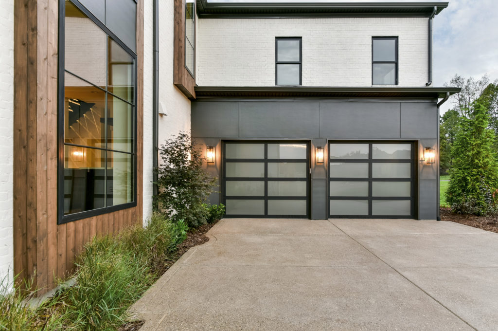 Brand new Clopay aluminum black garage door with frosted glass.