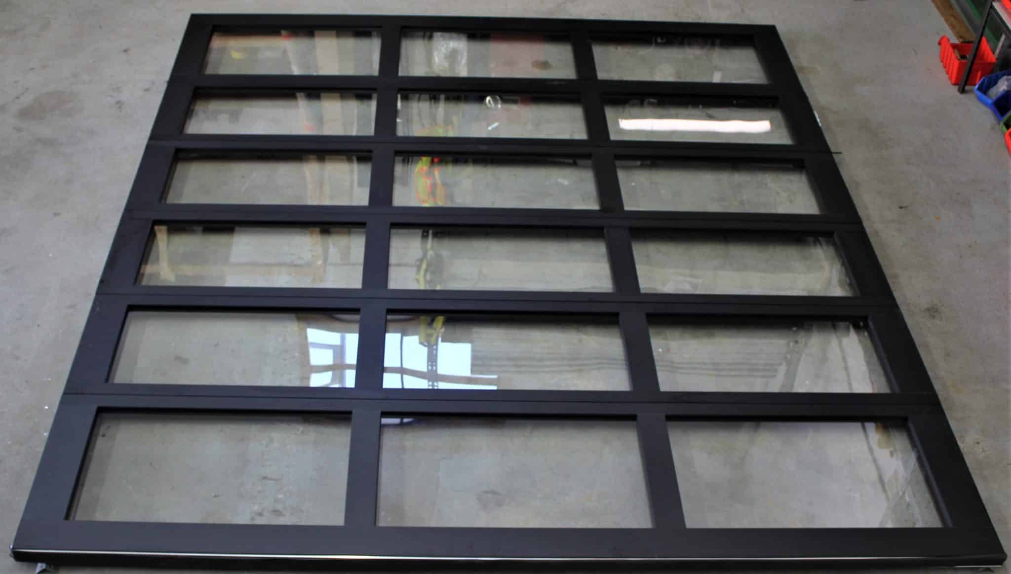 Read more about the article Brand new Clopay aluminum door model 904 anondized black with single pane glass full view. 10’2″ wide x 11’0″ high
